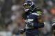 Seattle Seahawks cornerback Richard Sherman runs on the field in the first half of a preseason NFL football game against the Chicago Bears, Friday, Aug. 22, 2014, in Seattle. (AP Photo/John Froschauer)