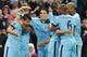 Manchester City's Sergio Aguero, left, celebrates with team mates after scoring against Liverpool during the English Premier League soccer match between Manchester City and Liverpool at the Etihad Stadium, in Manchester, England, Monday, Aug. 25, 2014. (AP Photo/Rui Vieira)