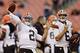 Cleveland Browns quarterback Johnny Manziel (2) warms up as Brian Hoyer (6) watches before a preseason NFL football game against the Chicago Bears, Thursday, Aug. 28, 2014, in Cleveland. (AP Photo/Tony Dejak)