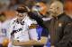 Cleveland Browns head coach Mike Pettine, right, pats quarterback Johnny Manziel on the head as they leave the field at halftime of a preseason NFL football game against the Chicago Bears, Thursday, Aug. 28, 2014, in Cleveland. (AP Photo/Tony Dejak)