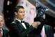 Named the best player of the year, Real Madrid Portuguese forward Cristiano Ronaldo, holds his trophy during the UEFA Champions League draw, at the Grimaldi Forum, in Monaco, Thursday, Aug. 28, 2014. (AP Photo/Claude Paris)