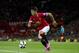 Manchester United's Shinji Kagawa takes the ball downfield, during his team's pre season friendly soccer match against Valencia at Old Trafford Stadium, Manchester, England, Tuesday Aug. 12, 2014. (AP Photo/Jon Super)