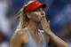 Maria Sharapova, of Russia, blows kisses to the crowd after defeating Alexandra Dulgheru, of Romania, during the second round of the 2014 U.S. Open tennis tournament, Wednesday, Aug. 27, 2014, in New York. (AP Photo/Matt Rourke)