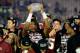 PASADENA, CA - JANUARY 06: Quarterback Jameis Winston #5 of the Florida State Seminoles holds the Coaches' Trophy after defeating the Auburn Tigers 34-31 in the 2014 Vizio BCS National Championship Game at the Rose Bowl on January 6, 2014 in Pasadena, California. (Photo by Harry How/Getty Images)