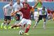 FILE - In this July 26, 2014 file photo, AS Roma's Francesco Totti kicks for a goal during an exhibition soccer match against Manchester United at Mile High Stadium in Denver, Co. For Italian football fans, merely mentioning the word