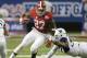 Alabama running back Derrick Henry (27) tries to escape from West Virginia defensive lineman Noble Nwachukwu (97) in the second half of an NCAA college football game Saturday, Aug. 30, 2014, in Atlanta. (AP Photo/John Bazemore)