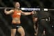Bethe Correia, left, celebrates after defeating Shayna Baszler, rear, who is tended to by referee John McCarthy after a women's bantamweight mixed martial arts bout at UFC 177 in Sacramento, Calif., Saturday, Aug. 30, 2014. Correia won in the second round. (AP Photo/Jeff Chiu)