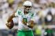 Oregon quarterback Marcus Mariota runs the football during the second quarter of an NCAA college football game against South Dakota in Eugene, Ore., Saturday, Aug. 30, 2014. (AP Photo/Ryan Kang)