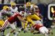 HOUSTON, TX - AUGUST 30: Kenny Hilliard #27 of the LSU Tigers is tackled by Konrad Zagzebski #91 of the Wisconsin Badgers at NRG Stadium on August 30, 2014 in Houston, Texas. Zagzebeski was injured on the play and to be taken off on a stretcher. (Photo by Bob Levey/Getty Images)