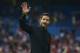 Atletico's coach Diego Simeone from Argentina, salutes the fans during a Spanish La Liga soccer match between Atletico de Madrid and Eibar at the Vicente Calderon stadium in Madrid, Spain, Saturday, Aug. 30, 2014. (AP Photo/Andres Kudacki)