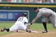 Detroit Tigers' Rajai Davis safely beats the tag of Colorado Rockies second baseman D.J. LeMahieu on a double to center field during the third inning of an interleague baseball game, Sunday, Aug. 3, 2014, in Detroit. (AP Photo/Carlos Osorio)