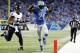 Detroit Lions running back Reggie Bush (21) scores ahead of Baltimore Ravens inside linebacker Daryl Smith (51) for a 14-yard touchdown during the first quarter of an NFL football game in Detroit, Monday, Dec. 16, 2013. (AP Photo/Rick Osentoski)