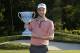 Chris Kirk holds the trophy after winning the Deutsche Bank Championship golf tournament in Norton, Mass., Monday, Sept. 1, 2014. (AP Photo/Michael Dwyer)