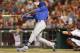 Chicago Cubs' Jorge Soler gets a hit off Cincinnati Reds relief pitcher Jonathan Broxton to drive in a run in the eighth inning of a baseball game, Wednesday, Aug. 27, 2014, in Cincinnati. Soler was making his major league debut. Cincinnati won 7-5. Devin Mesoraco catches at right. (AP Photo/Al Behrman)