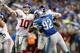 DETROIT, MI - DECEMBER 22: Eli Manning #10 of the New York Giants throws a second quarter touchdown pas behind the rush of Devin Taylor #92 of the Detroit Lions at Ford Field on December 22, 2013 in Detroit, Michigan. (Photo by Gregory Shamus/Getty Images)