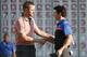 Chris Kirk, left, shakes hands with Rory McIlroy after finishing on the 18th hole of the Deutsche Bank Championship golf tournament in Norton, Mass., Monday, Sept. 1, 2014. Kirk won with 15-under par. (AP Photo/Michael Dwyer)