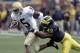 Michigan linebacker John Thompson brings down Notre Dame's Armando Allen (5) during the third quarter of a football game at Michigan Stadium in Ann Arbor, Mich., Saturday, Sept. 15, 2007. Hart ran for 187 yards on 35 carries and scored two touchdowns to help the Wolverines to a 38-0 win over Notre Dame. Michigan handed the Fighting Irish their worst loss since beating them by the same score in 2003. (AP Photo/Carlos Osorio)