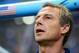 SALVADOR, BRAZIL - JULY 01: Head coach Jurgen Klinsmann of the United States sings the National Anthem prior to the 2014 FIFA World Cup Brazil Round of 16 match between Belgium and the United States at Arena Fonte Nova on July 1, 2014 in Salvador, Brazil. (Photo by Laurence Griffiths/Getty Images)