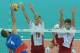 Serbia's Nikola Kovacevic, left, spikes the ball against Poland's Mariusz Wlazly, center, and Piotr Nowakowski during their game opening the FIVB Men's Volleyball World Championships at the National Stadium in Warsaw, Poland, Saturday, Aug. 30, 2014. (AP Photo/Alik Keplicz)