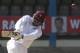 West Indies opening batsman Chris Gayle, left, plays a shot during the second innings on the last day of the second cricket Test match against New Zealand in Port of Spain, Trinidad, Friday, June 20, 2014. West Indies won the second Test match by 10 wickets tying the series 1-1. (AP Photo/Arnulfo Franco)