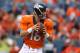 DENVER, CO - AUGUST 07: Quarterback Peyton Manning #18 of the Denver Broncos drops back to pass against the Seattle Seahawks during preseason action at Sports Authority Field at Mile High on August 7, 2014 in Denver, Colorado. (Photo by Doug Pensinger/Getty Images)