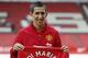 Manchester United's new player Angel Di Maria poses for photographers holding his new shirt, at Old Trafford Stadium in Manchester, England, Thursday, Aug. 28, 2014. Manchester United have signed winger Angel Di Maria from Real Madrid for a British record transfer fee of £59.7m. The Argentine winger had a medical in Manchester on Tuesday and has signed a five-year deal. (AP Photo/Alastair Grant)