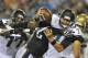 Jacksonville Jaguars quarterback Chad Henne, right, is sacked by Philadelphia Eagles tackle Michael Bamiro, center, as he gets past guard Uche Nwaneri (77) during the first half of an NFL preseason football game, Saturday, Aug. 24, 2013, in Jacksonville, Fla. (AP Photo/Stephen Morton)