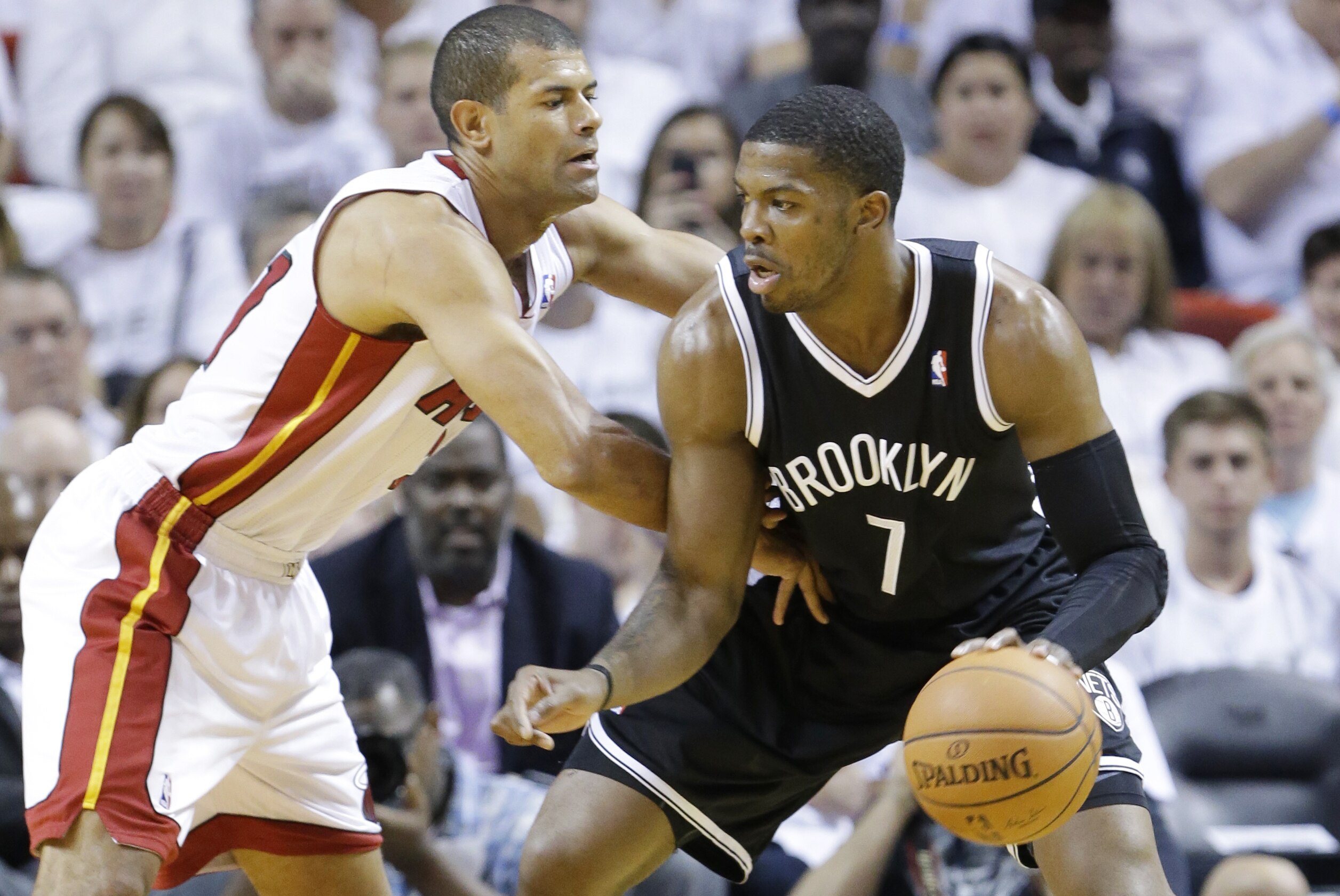 Brooklyn Nets guard Joe Johnson (7) drives up against Miami Heat forward Shane Battier during the first half of Game 2 of an Eastern Conference semifinal basketball game, Thursday, May 8, 2014 in Miami. (AP Photo/Wilfredo Lee)