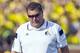 Michigan head coach Brady Hoke, right, reacts on the sideline next to defensive coordinator Greg Mattison, left, in the second quarter of an NCAA college football game against Minnesota in Ann Arbor, Mich., Saturday, Sept. 27, 2014. (AP Photo/Tony Ding)