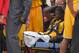 Los Angeles Lakers forward Julius Randle, right, sits on on a stretcher after Randle injured himself on a play during the second half of an NBA basketball game, Tuesday, Oct. 28, 2014, in Los Angeles. (AP Photo/Mark J. Terrill)