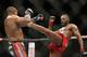 Jon Jones kicks Daniel Cormier during their light heavyweight title mixed martial arts bout at UFC 182, Saturday, Jan. 3, 2015, in Las Vegas. (AP Photo/John Locher)