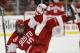 Boston University's Corey Trivino (10) is upended by Boston College's Brian Gibbons during the first period of a Beanpot college hockey tournament game in Boston on Monday, Feb. 7, 2011. (AP Photo/Winslow Townson)