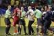 Panama's Anibal Godoy (20) approaches referee Mark Geiger, left, as officials rush in to protect him at the conclusion of a CONCACAF Gold Cup soccer semifinal between Panama and Mexico on Wednesday, July 22, 2015, in Atlanta. Mexico won 2-1. (AP Photo/David Goldman)