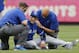 Toronto Blue Jays staff tend to Toronto Blue Jays shortstop Troy Tulowitzki, center, after he collided with Blue Jays center fielder Kevin Pillar fielding a fly ball in the second inning of a baseball game at Yankee Stadium in New York, Saturday, Sept. 12, 2015. Tulowitzki left the game. (AP Photo/Kathy Willens)