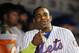 New York Mets Yoenis Cespedes smiles in the dugout after hiting a third-inning, solo, home run in a baseball game against the Miami Marlins in New York, Monday, Sept. 14, 2015. (AP Photo/Kathy Willens)