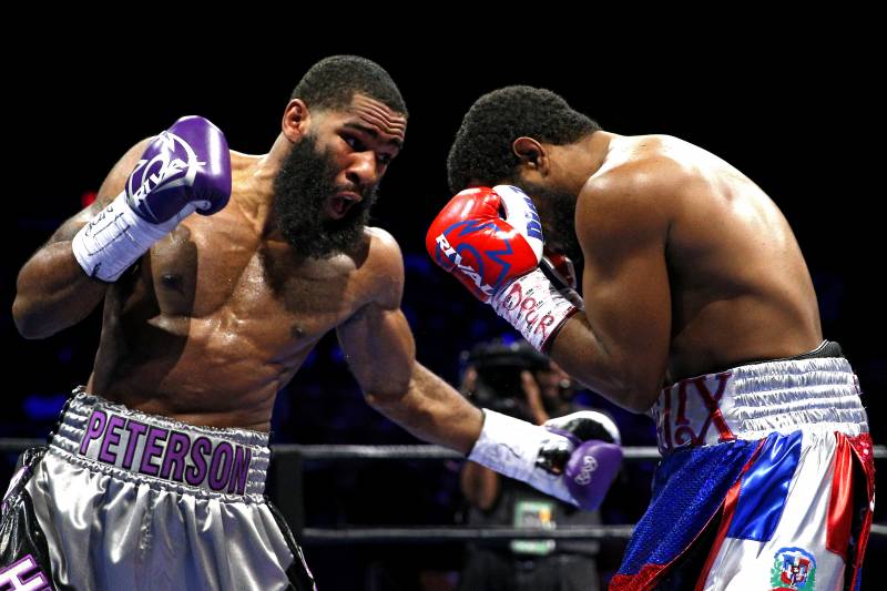 FAIRFAX, VA - OCTOBER 17: Lamont Peterson punches Felix Diaz Jr. during their welterweight bout on the campus of George Mason University on October 17, 2015 in Fairfax, Virginia. Peterson won on judges decision. (Photo by Patrick Smith/Getty Images