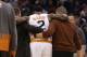Phoenix Suns guard Eric Bledsoe (2) is helped off the court in the second quarter during an NBA basketball game against the Philadelphia 76ers, Saturday, Dec. 26, 2015, in Phoenix. (AP Photo/Rick Scuteri)