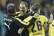 Dortmund head coach Thomas Tuchel, center, celebrates after the German Bundesliga soccer match between Borussia Dortmund and FC Schalke 04 in Dortmund, Germany, Sunday, Nov. 8, 2015. Dortmund defeated Schalke with 3-2. (AP Photo/Martin Meissner)