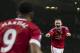 Manchester United's Wayne Rooney, right, celebrates with teammate Anthony Martial after scoring during the English Premier League soccer match between Manchester United and Swansea City at Old Trafford Stadium, Manchester, England, Saturday, Jan. 2, 2016. (AP Photo/Jon Super)