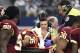 Washington Redskins' Dashaun Phillips (35) is carted off the field by first responders as Ricky Jean Francois (99) watches in the first half of an NFL football game against the Dallas Cowboys, Sunday, Jan. 3, 2016, in Arlington, Texas. Phillips was injured while helping stop Cowboys running back Darren McFadden on a running play. (AP Photo/Michael Ainsworth)