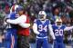 Buffalo Bills head coach Rex Ryan hugs Buffalo Bills' Manny Lawson (91) after Lawson intercepted a pass during the second half of an NFL football game against the New York Jets Sunday, Jan. 3, 2016, in Orchard Park, N.Y. The Bills won 22-17. (AP Photo/Gary Wiepert)