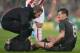 Liverpool's Croatian defender Dejan Lovren (R) receives treatment for an injury before being substituted in the first half during the English League Cup semi-final first leg football match at Britannia Stadium in Stoke-on-Trent, central England, on January 5, 2015. AFP PHOTO / OLI SCARFF
RESTRICTED TO EDITORIAL USE. No use with unauthorized audio, video, data, fixture lists, club/league logos or 'live' services. Online in-match use limited to 75 images, no video emulation. No use in betting, games or single club/league/player publications. / AFP / OLI SCARFF (Photo credit should read OLI SCARFF/AFP/Getty Images)