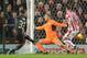 Liverpool's English midfielder Jordon Ibe (L) strikes the ball past Stoke City's English goalkeeper Jack Butland (C) to score the opening goal during the English League Cup semi-final first leg football match at Britannia Stadium in Stoke-on-Trent, central England, on January 5, 2015. AFP PHOTO / OLI SCARFFRESTRICTED TO EDITORIAL USE. No use with unauthorized audio, video, data, fixture lists, club/league logos or 'live' services. Online in-match use limited to 75 images, no video emulation. No use in betting, games or single club/league/player publications. / AFP / OLI SCARFF (Photo credit should read OLI SCARFF/AFP/Getty Images)