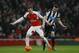 Arsenal's Aaron Ramsey, left, competes for the ball with Newcastle United's Paul Dummett during the English Premier League soccer match between Arsenal and Newcastle United at Emirates stadium in London, Saturday, Jan. 2, 2016. (AP Photo/Kirsty Wigglesworth)