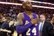 Los Angeles Lakers' Kobe Bryant touches his chest as he walks of the court in Boston after the Lakers' 112-104 win over the Boston Celtics in an NBA basketball game Wednesday, Dec. 30, 2015.(AP Photo/Winslow Townson)