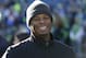 Former Seattle Mariners' Ken Griffey Jr. smiles as he stands on the sidelines before an NFL football game between the Seattle Seahawks and San Francisco 49ers, Sunday, Dec. 14, 2014, in Seattle. (AP Photo/Elaine Thompson)