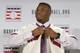Ken Griffey Jr. buttons up his Hall of Fame jersey after he and Mike Piazza were announced as electees into the 2016 Baseball Hall of Fame class, Thursday, Jan. 7, 2016, in New York. (AP Photo/Kathy Willens)