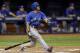 Toronto Blue Jays' Ben Revere hits an RBI sacrifice fly off Tampa Bay Rays relief pitcher Enny Romero during the sixth inning of a baseball game Friday, Oct. 2, 2015, in St. Petersburg, Fla. Blue Jays' Ryan Goins scored on the play. (AP Photo/Chris O'Meara)