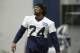 Seattle Seahawks running back Marshawn Lynch holds a candy cane in his mouth as he warms up before NFL football practice, Wednesday, Jan. 6, 2016, in Renton, Wash. Lynch has been recovering since having abdominal surgery last November. (AP Photo/Ted S. Warren)