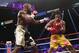 Floyd Mayweather Jr. exchange punches with Manny Pacquiao during their welterweight unification championship bout, May 2, 2015 at MGM Grand Garden Arena in Las Vegas, Nevada. Mayweather defeated Pacquiao by unanimous decision. AFP PHOTO / JOHN GURZINKSI (Photo credit should read JOHN GURZINSKI/AFP/Getty Images)